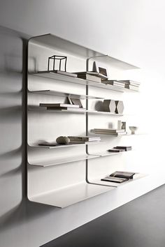 a white shelf with many books on it