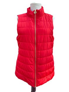 Elevate your winter and fall wardrobe with this vintage Michael Kors Red Quilted Puffer jacket vest. The vest features a full zip closure, red lined interior, and multiple pockets for added convenience. The classic fit makes it suitable for both travel and casual occasions. Crafted with quality materials and designed with attention to detail, this vest is perfect for women who want to stay warm and stylish. The accents of the zipper add a touch of designer flair to the overall look. This vest is a must-have for any fashion-forward woman who wants to embrace the outdoors in a classic and timeless style. Measures: Shoulder to shoulder: 14"; collar to hem: 26"; Bust: 36"; Waist: 40" [measurements taken lying flat] Please view the photos as they are very much a part of the description and you Puffer Jacket Vest, Zip Up Vest, Red Vest, Red Quilts, Quilted Puffer Jacket, Jacket Vest, Vest Outfits, Fall Wardrobe, Puffer Jacket