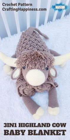 the stuffed animal is wearing a knitted hat with horns on it's head