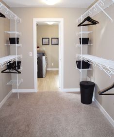 an empty room with some clothes hanging on the racks