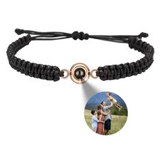 an adjustable bracelet with a photo on it and a round button attached to the clasp