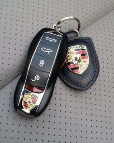 two car keys are sitting next to each other