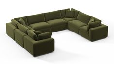 a large green couch with pillows on it's back and side facing each other