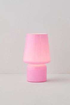 a pink lamp sitting on top of a white table