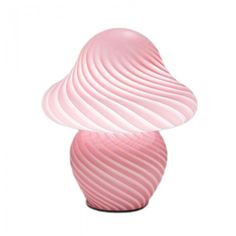 a pink vase sitting on top of a white table