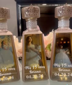 three personalized perfume bottles with pictures on them