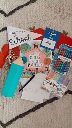 a pile of school supplies sitting on top of a rug