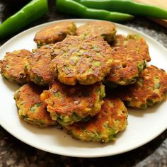 a white plate topped with crab cakes next to green beans