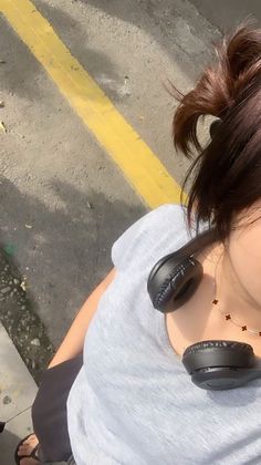 a woman with headphones on her ears