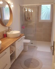 a bathroom with two sinks, a toilet and a shower stall in it's corner