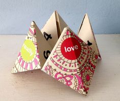 an origami fortune card holder with the word love on it