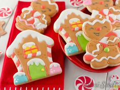 gingerbread cookies decorated with icing and candy canes on a red platter