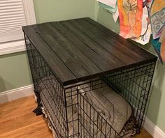 a dog cage is sitting on top of a wooden table