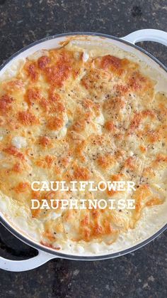 a close up of a casserole in a pan with the words cauliflower dauphnote on it