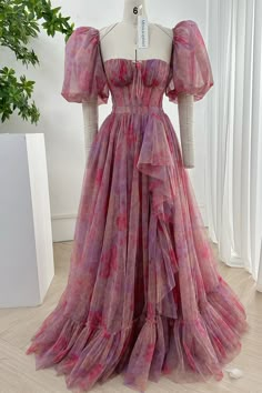 Introducing our exquisite Strapless Floral Tulle Long Dress. Designed with delicate removable puff sleeves, this dress will bring an air of romance and refinement to any occasion. With its luxurious tulle fabric and elegant floral pattern, this dress is a timeless work of art, fit for a true fashion connoisseur. Bust and Skirt with full lining. 100% Polyester 100% Recycled polyester lining Concealed zip at centre back Imported Floral Evening Dress Long, Luxury Romantic Ruched Puff Sleeve Dress, Luxury Dress With Ruched Bodice And Puff Sleeves, Pink Long Puffy Sleeve Dress, Floral Dress Puffy Sleeves Formal, Luxury Romantic Puff Sleeve Dress For Formal Occasions, Luxury Romantic Puff Sleeve Party Dress, Long Puff Dress Pink, Luxury Romantic Puff Sleeve Dress With Ruched Detail