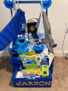 a blue toy cart filled with toys on the floor