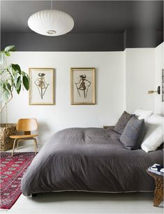 a bed sitting in a bedroom on top of a rug next to a table and chair