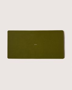 an olive green place mat on a white background