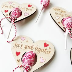 valentine's day lollipops in wooden hearts with sayings on them