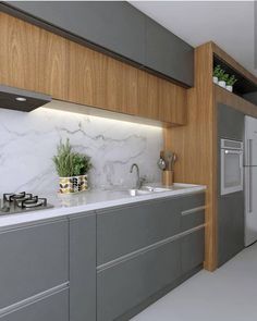 a modern kitchen with marble counter tops and stainless steel appliances