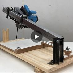 a machine that is sitting on top of a wooden board with tools attached to it