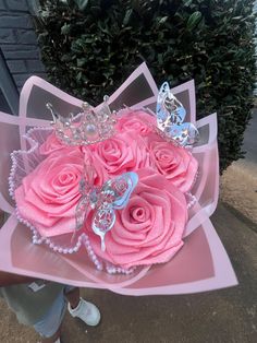 a bouquet of pink roses with butterflies on them