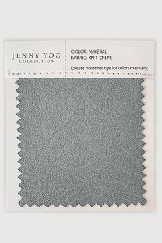 the fabric is gray and has a white border on it, which reads jenny yo collection