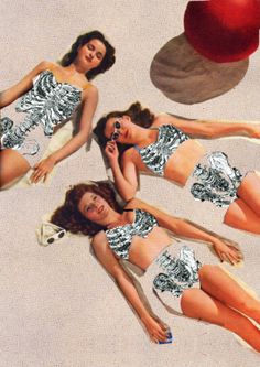 three women in swimsuits laying on the ground next to an apple and one is talking on a cell phone