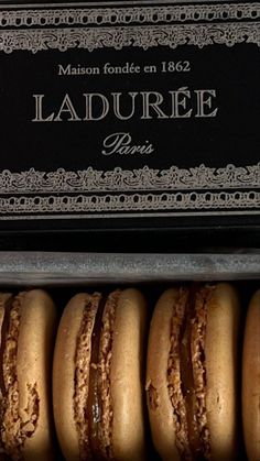 an assortment of french macarons in a metal box with the label laduree paris