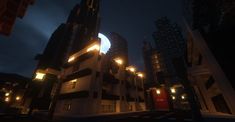 an image of a city at night with buildings lit up and lights on the building