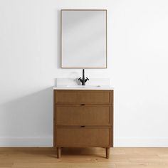 a bathroom vanity with a mirror above it and a wooden cabinet underneath the countertop