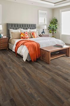 a bedroom with wood flooring and white walls