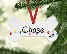 a dog bone ornament hanging on a christmas tree with the word chase printed on it