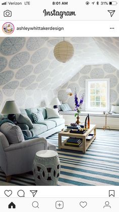 an instagram photo of a living room with blue and white decor on the walls