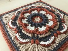 a crocheted square is sitting on a table