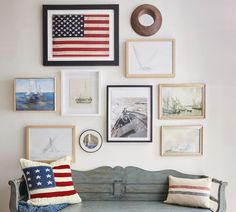 a blue bench sitting in front of a wall filled with pictures and framed art on it