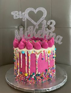 a birthday cake with pink frosting and sprinkles