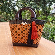 Introducing our handmade Thai straw bags, crafted with love and care by skilled artisans in Thailand. Each bag is made from high-quality, sustainable materials and features a beautiful woven design that is unique to each piece. The first thing you'll notice about our bag is the handcrafted wooden handle from Chiangmai. Made by skilled artisans using locally sourced wood, the handle adds a touch of rustic elegance to the design. It's both comfortable to hold and visually striking, making it the p Eco-friendly Orange Rectangular Straw Bag, Woven Jute Bag With Top Handle, Top Handle Woven Jute Bag, Woven Jute Top Handle Bag, Eco-friendly Palm Leaf Bag With Open Weave, Handwoven Rattan Vacation Bags, Natural Woven Rattan Bag, Crochet Jute Bag With Top Handle, Natural Woven Crochet Top Handle Bag