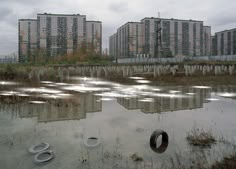 an abandoned city is reflected in the water