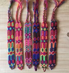 five colorful beads are lined up on a table