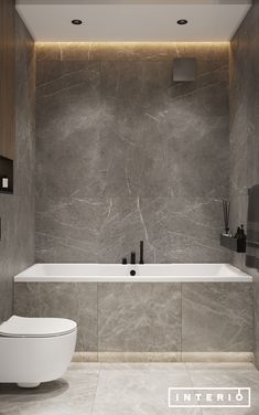 a white toilet sitting next to a bath tub in a bathroom