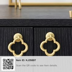 a close up of a drawer with two gold handles on it and a qr code to see item details