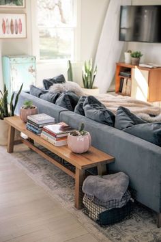 a living room filled with furniture and a flat screen tv mounted to the side of a wall