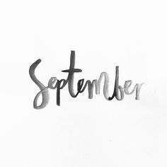 a black and white photo with the word september written in cursive writing