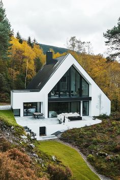 a white house in the middle of a forest