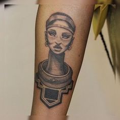 a woman's arm with a tattoo on it that has an image of a head