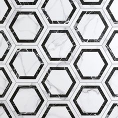 an abstract pattern made up of black and white hexagonals on a marble surface