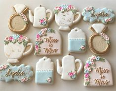 decorated cookies are arranged in the shape of teapots and kettles with flowers on them