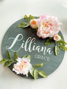 a sign with flowers on it that says lilliana grace