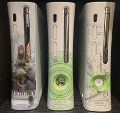 three nintendo wii game controllers on display in a store, one is green and the other is white